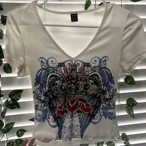 A white V Cut top with a colorful design